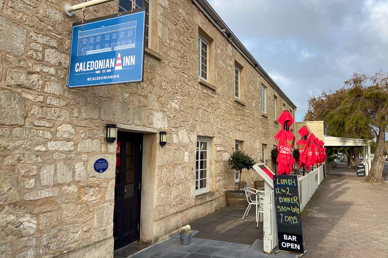 The outside of an old stone building with the sign 