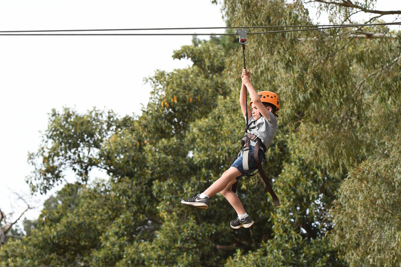 A young boy on a zip line